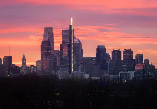 The skyline of Philadelphia with a pink sky