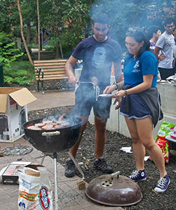 Gregory "Beach" with barbecue grill and students